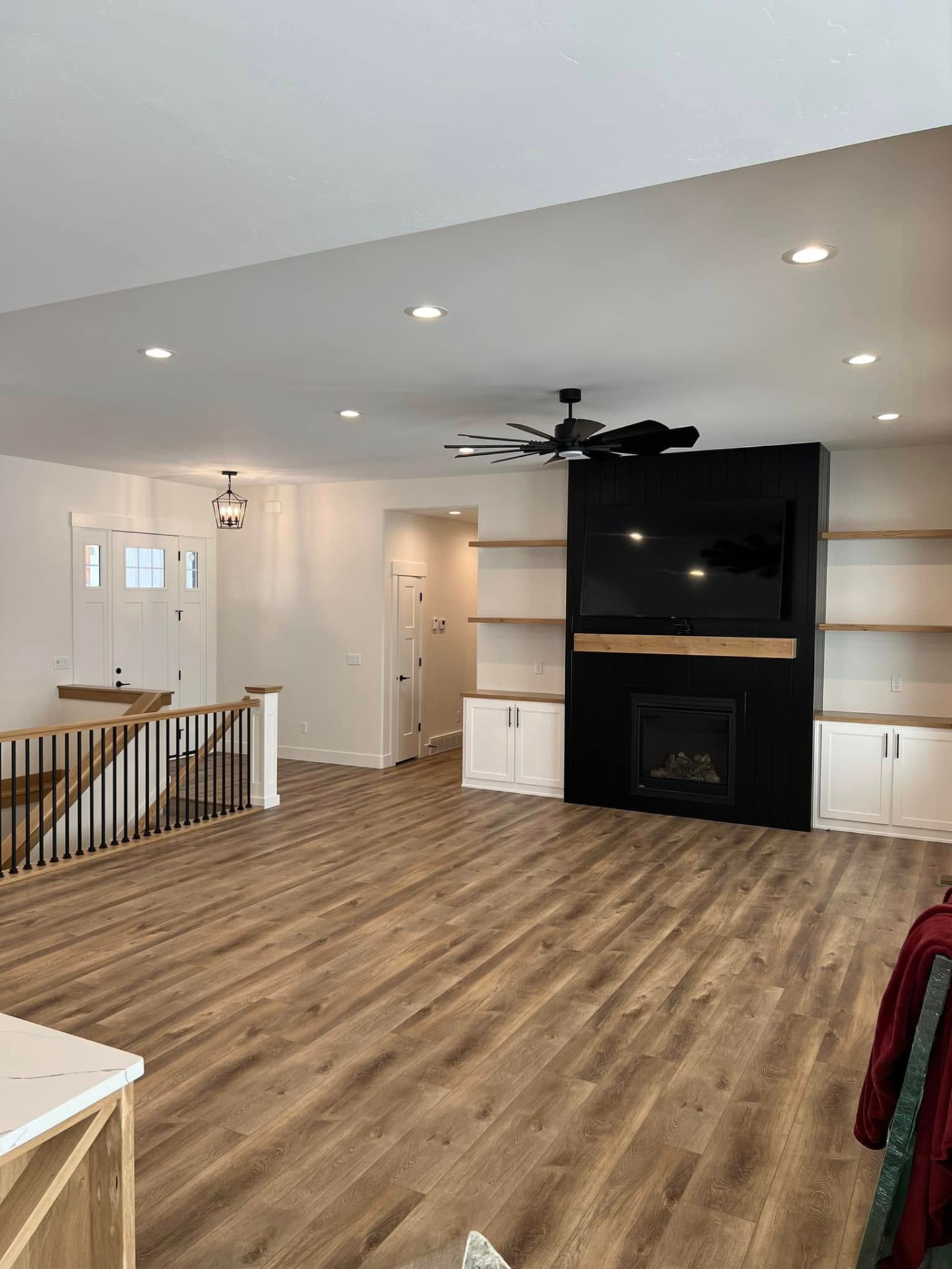 3156 Trappers family room with black shiplap fireplace and wood shelving