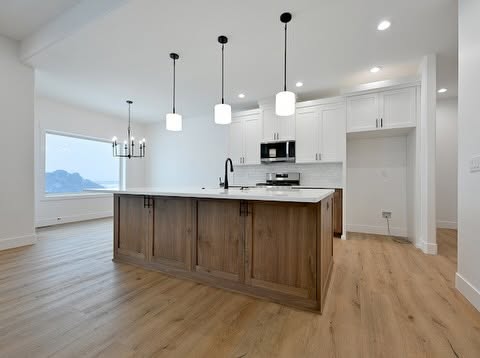 918 Jack Lane kitchen with wood island, quartz counters and black pendant lights