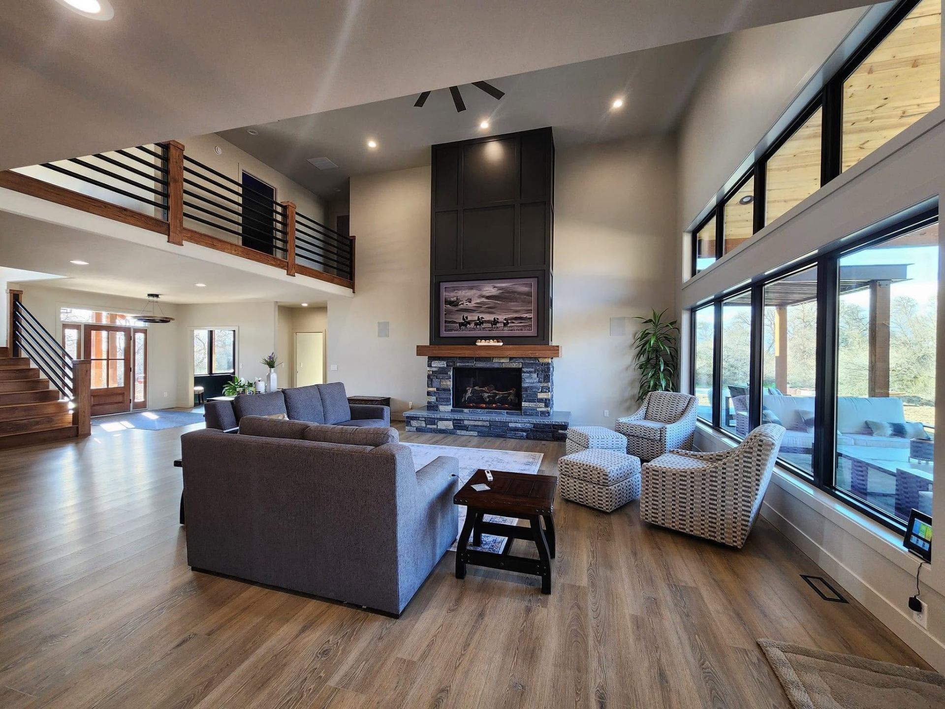 Stunning great room with vaulted ceilings and stone fireplace by Jones Construction